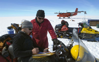 Scientists examining information in the snow.